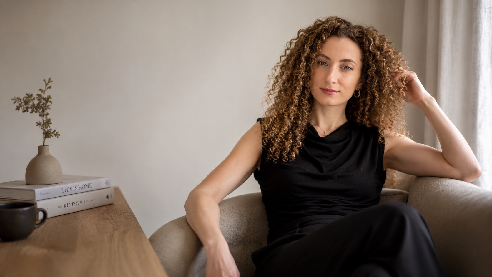 Portrait of author Christina Marcangelo seated beside a table